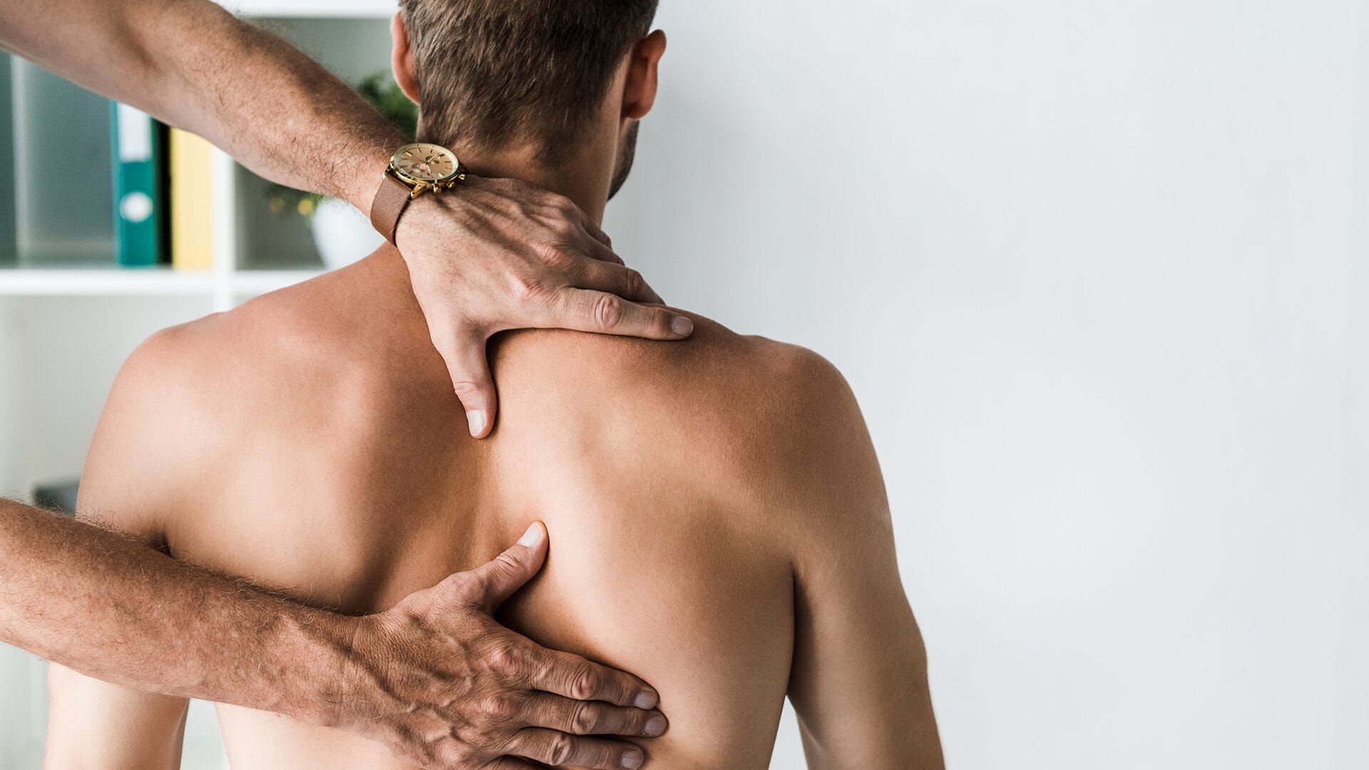 Male patient laying down during acupuncture and acutrigger therapy.